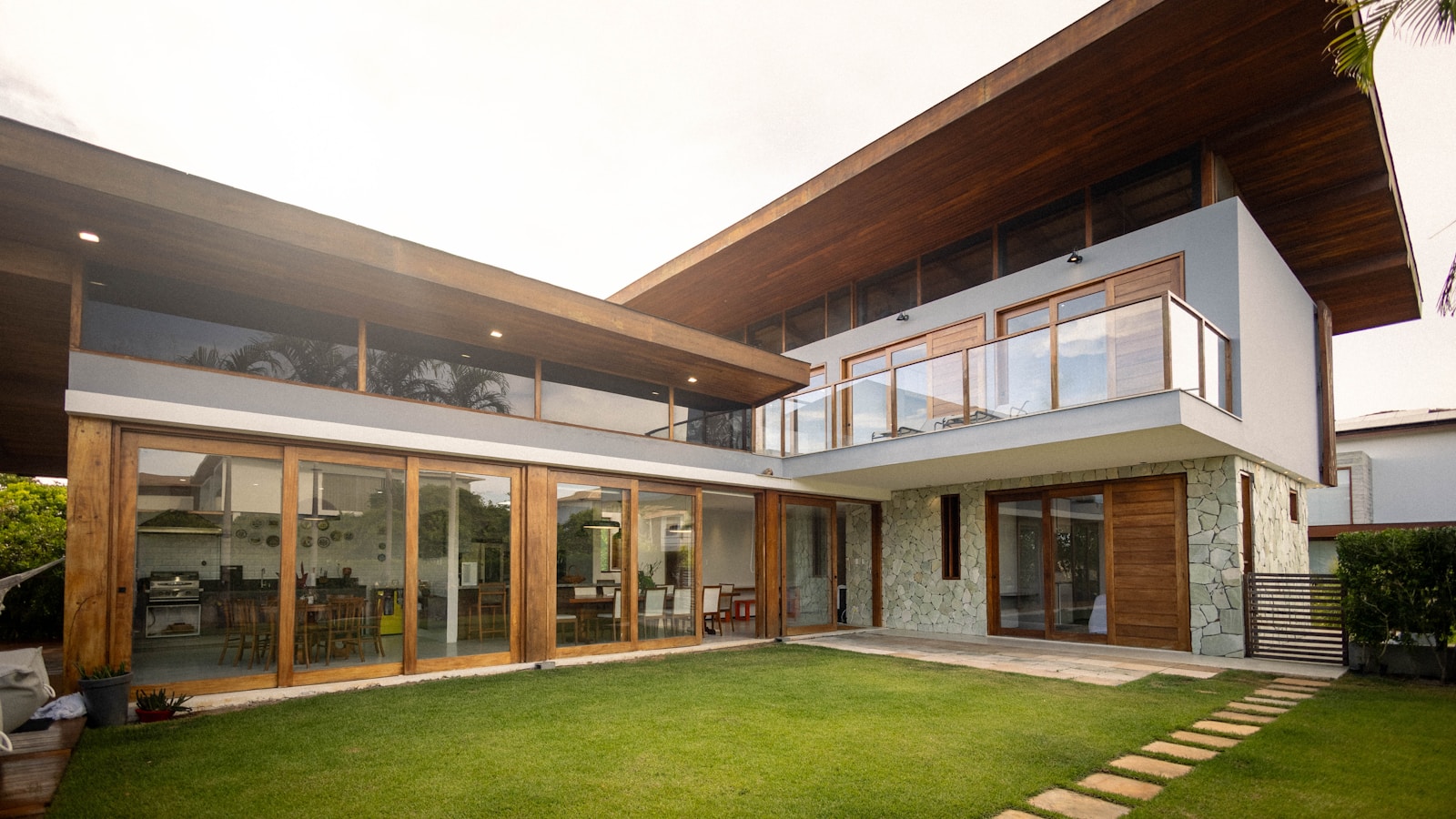 Modern investment property with large windows and a landscaped lawn